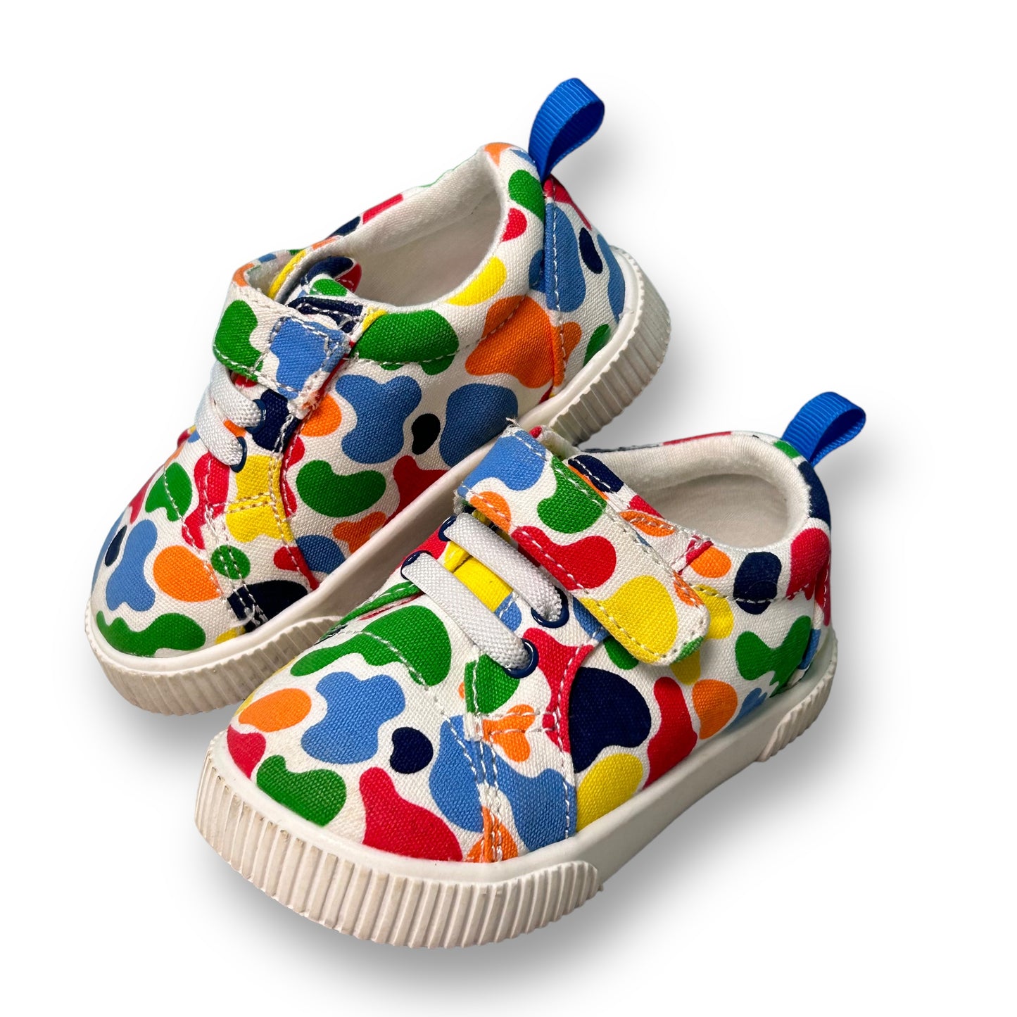 A pair of toddler boy sneakers with a colorful paint splatter pattern.