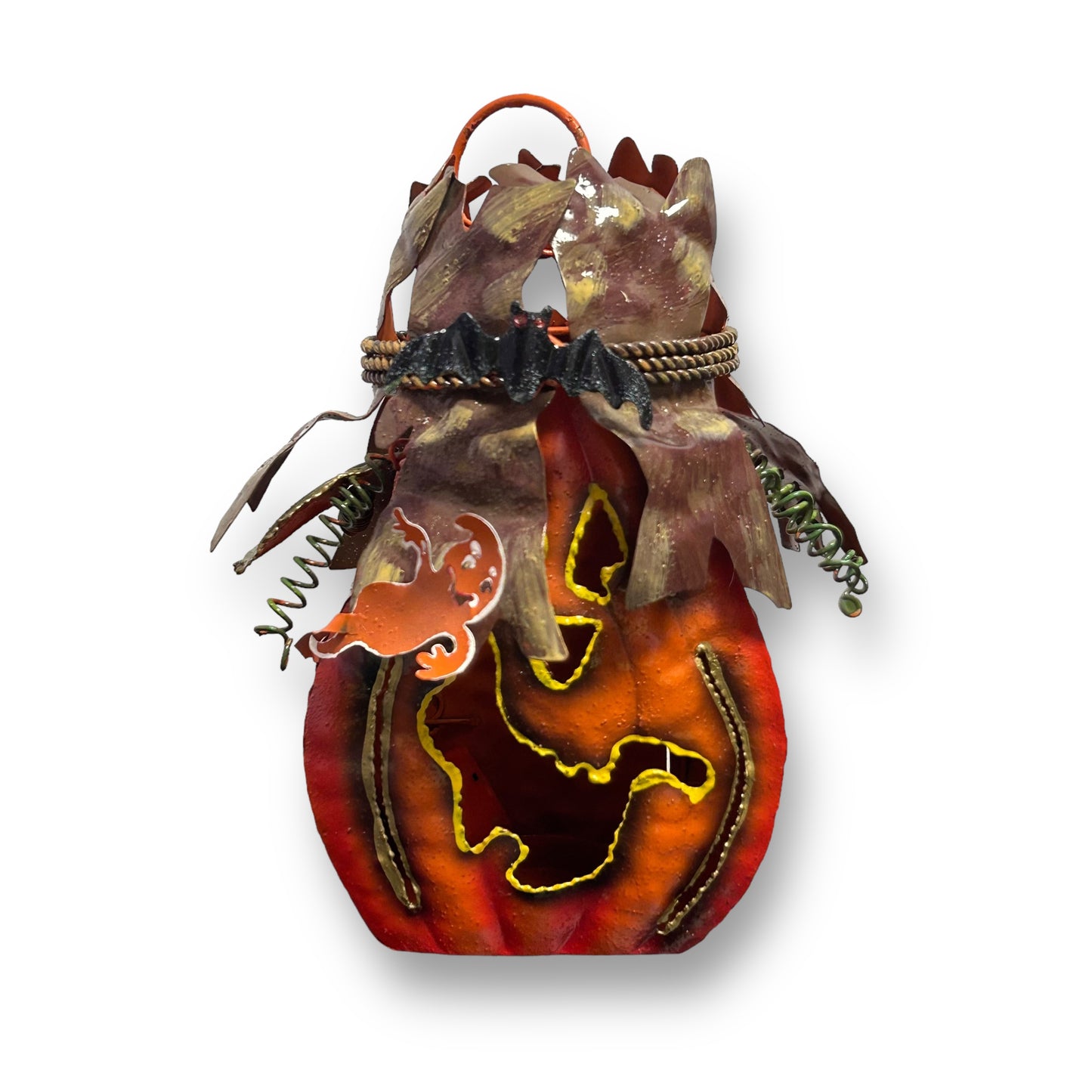 A Halloween-themed tin jack-o-lantern votive candle holder with a design that resembles a pumpkin and a bat.