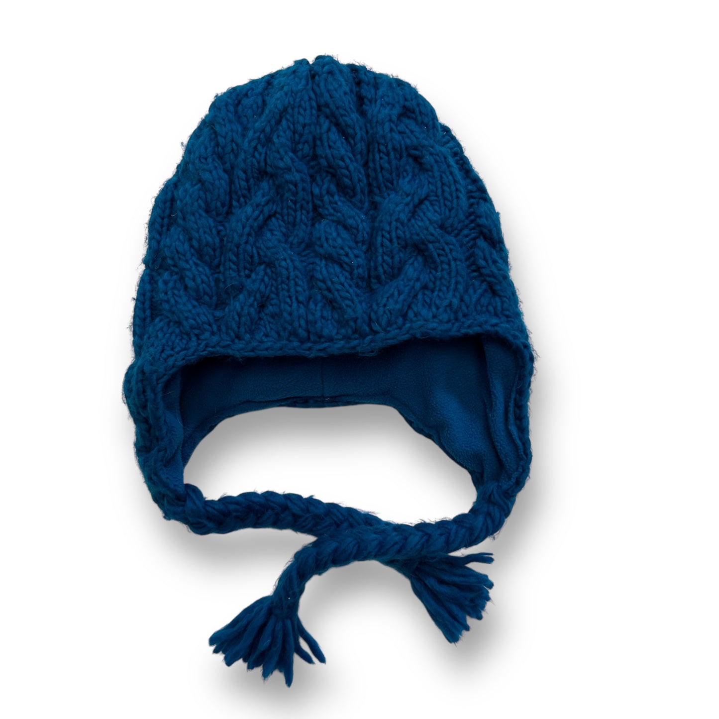 A teal blue knit fleece lined winter beanie hat for girls with a tassel on the brim.