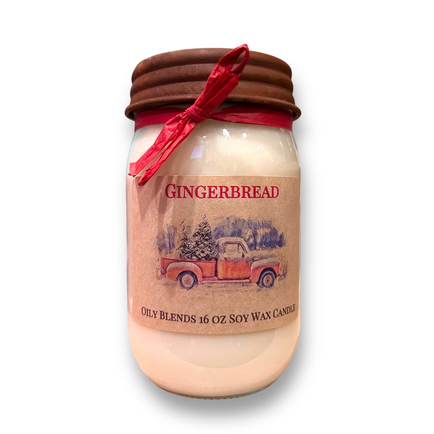 A clear jar with a brown lid and a red ribbon, labeled 'Gingerbread' with a picture of a gingerbread man and a Christmas tree in the background. The jar indicates it contains 16 oz.