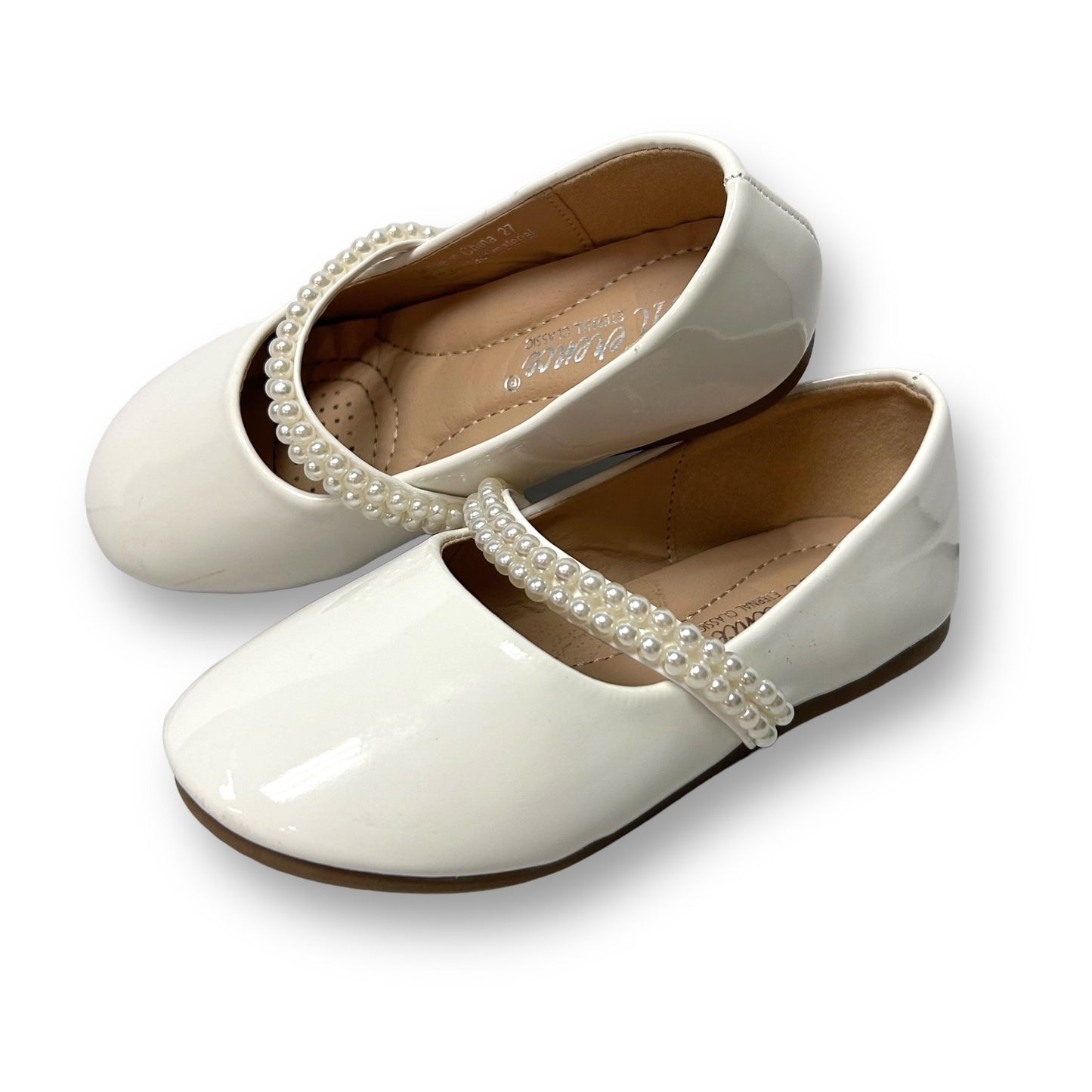 A pair of white pearl strap dress shoes for toddler girls.