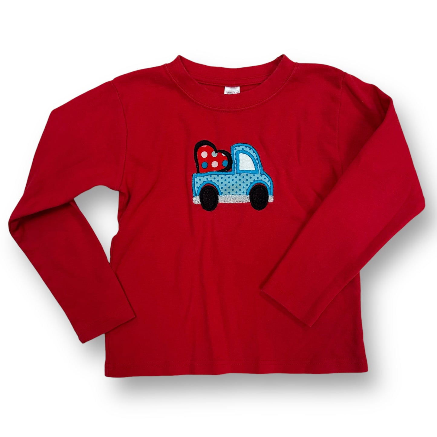 A red long sleeve girls' shirt with a graphic of a blue toy truck and hearts on the front.