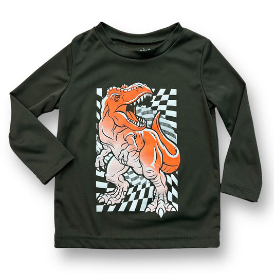 A long sleeve dark green active shirt for boys with a dinosaur pattern on it.