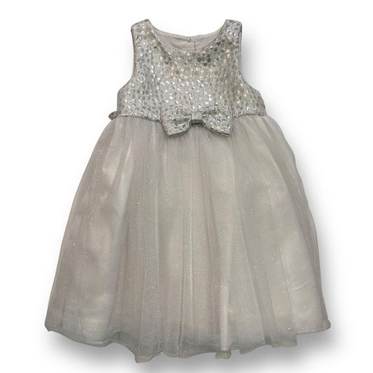 A size 2 girls' holiday dress with a shimmery tulle fabric and a bow embellishment on the neckline.