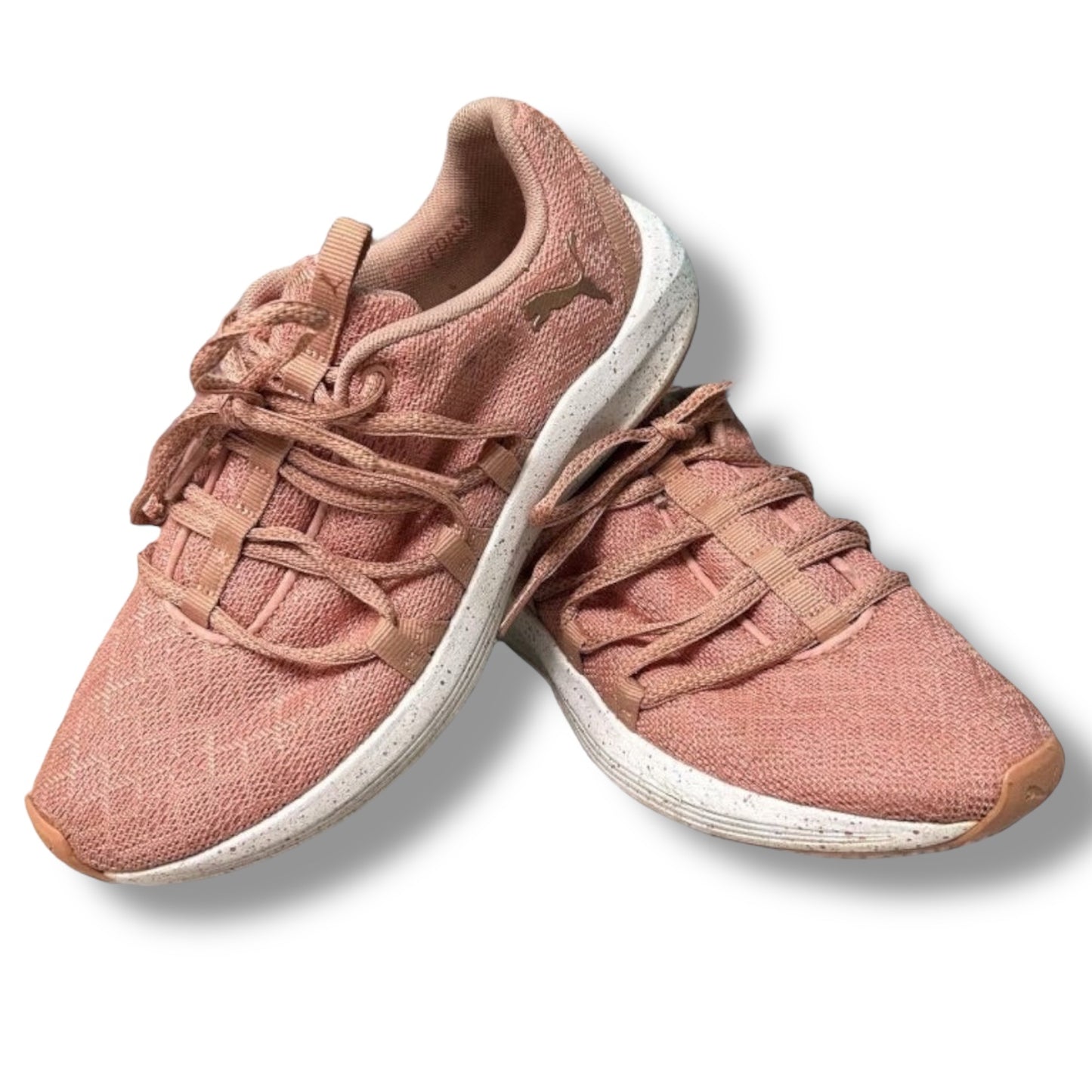 Pair of pink sneakers with white soles on a light background
