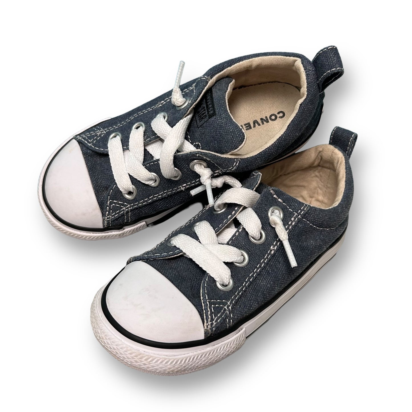 A pair of Converse All Star Kids blue slide-on sneakers with white laces.