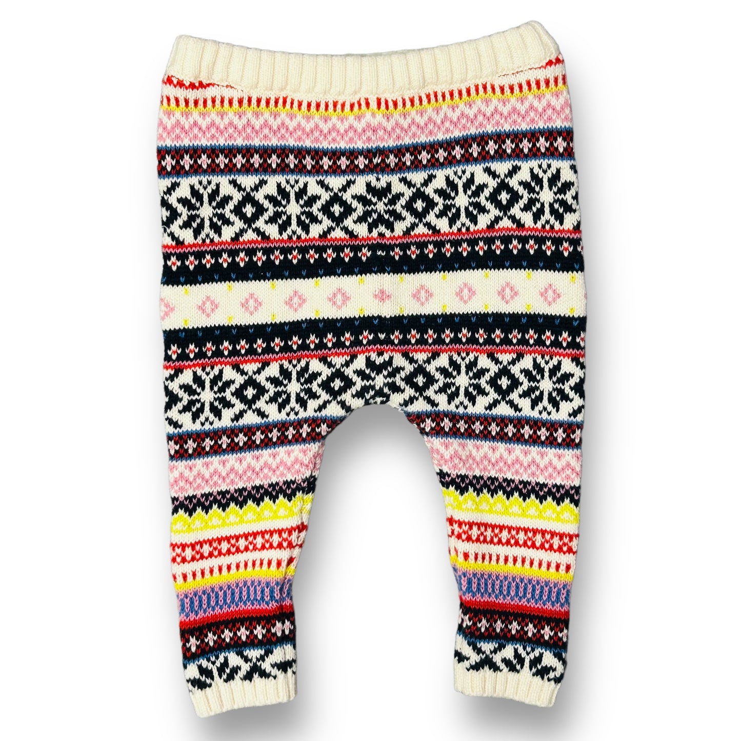 A pair of multicolored pull-on sweater leggings for girls, featuring a geometric pattern with colors including pink, white, black, and yellow.