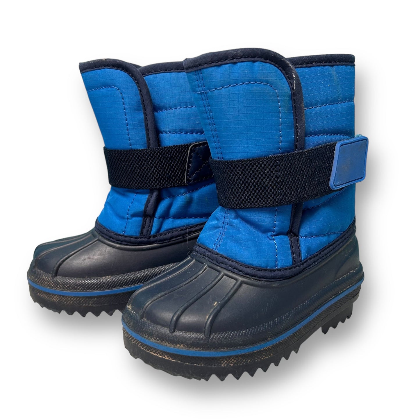 A pair of blue children's snow boots with black accents and a visible label.