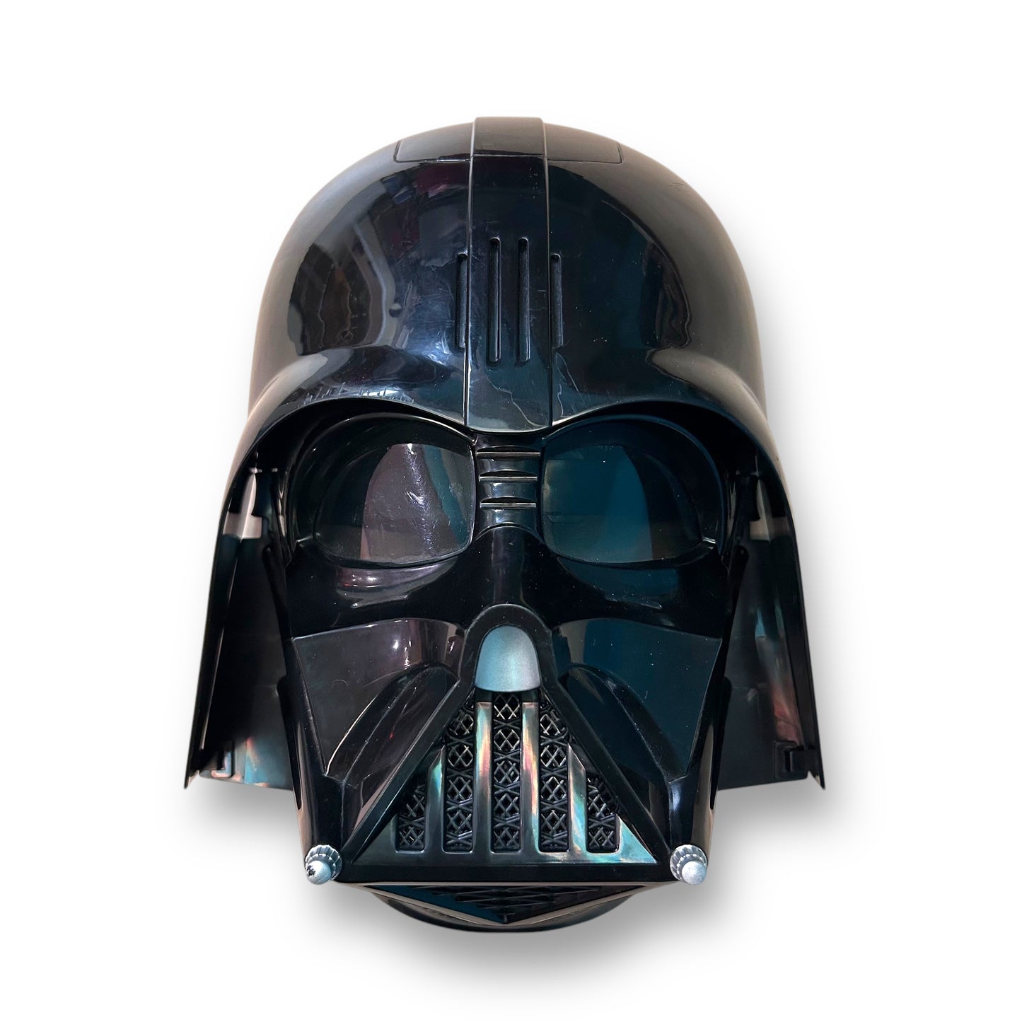 A Star Wars Darth Vader helmet mask with a black glossy finish and visible breathing apparatus.