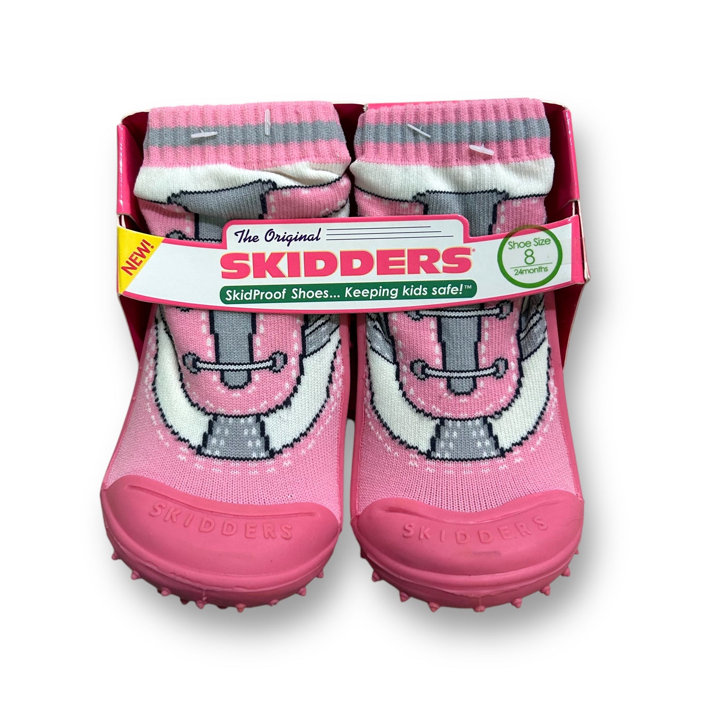 A pair of pink Skidders toddler shoes with a skidproof sole, designed for walking, displayed in packaging.