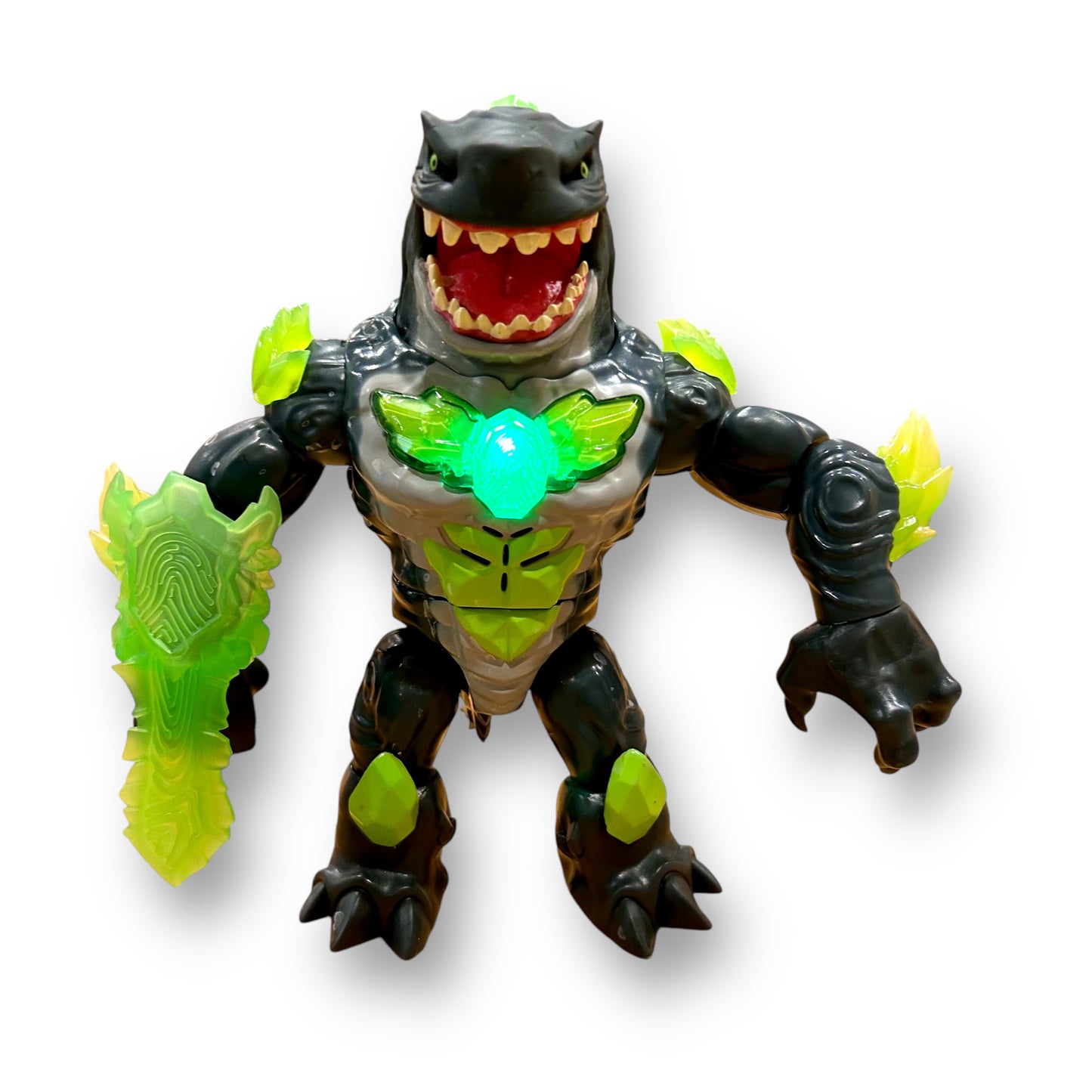 An action figure of a mega shark with a green and black color scheme, featuring lights and sounds, posed with an open mouth displaying sharp teeth.