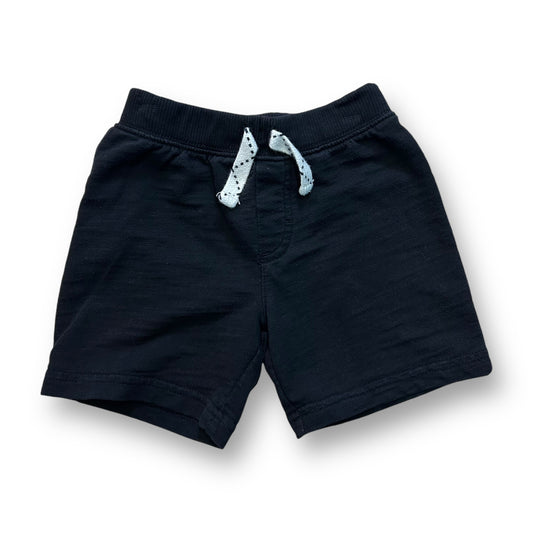 Black knit pull-on shorts for boys, with a waistband decoration.