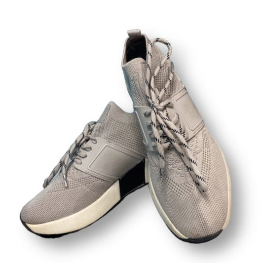 A pair of women's gray platform wedge comfort sneakers with laces.