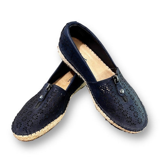 A pair of navy blue wedge leather slippers with a dotted pattern andEspadrille sole.