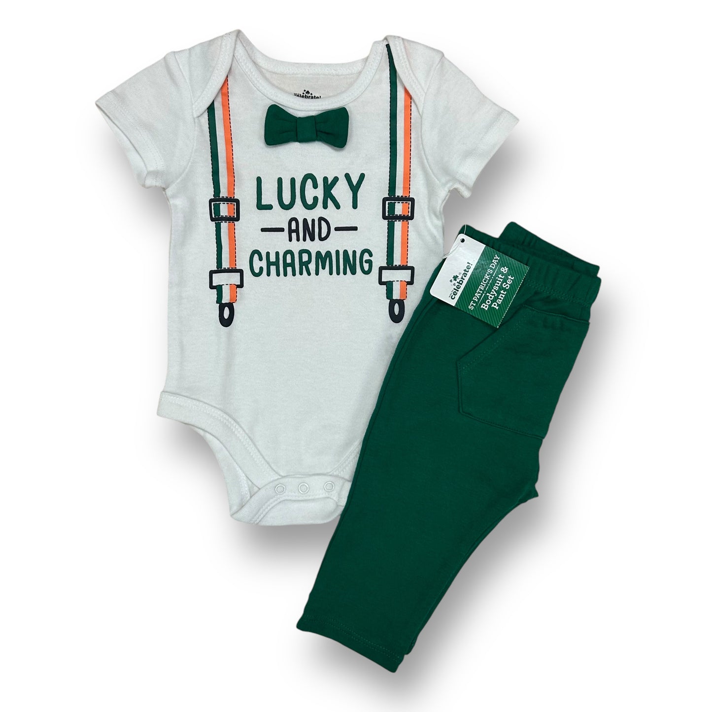A two-piece baby outfit set with a white bodysuit that has green trim and text reading 'LUCKY AND CHARMING', and green pants.