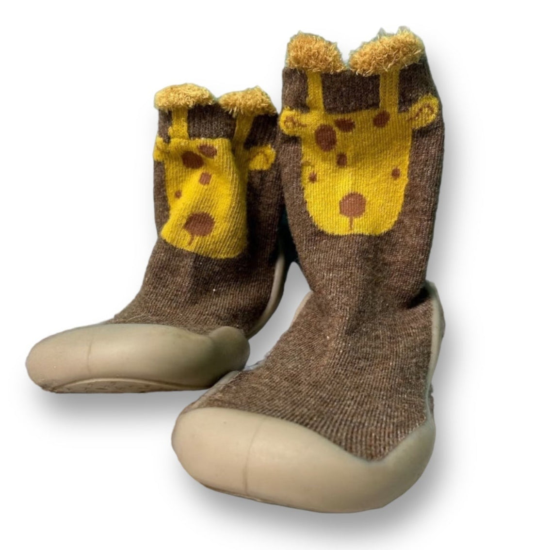 A pair of brown toddler slipper shoes with a character pattern and a plush cheese-like design on the top.