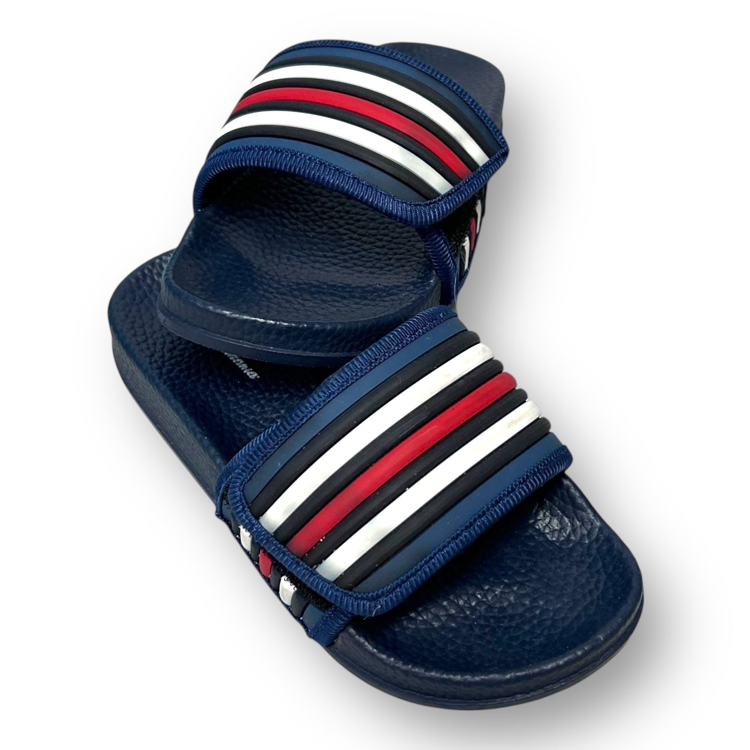 Navy slide sandal with red and white striped straps on a white background