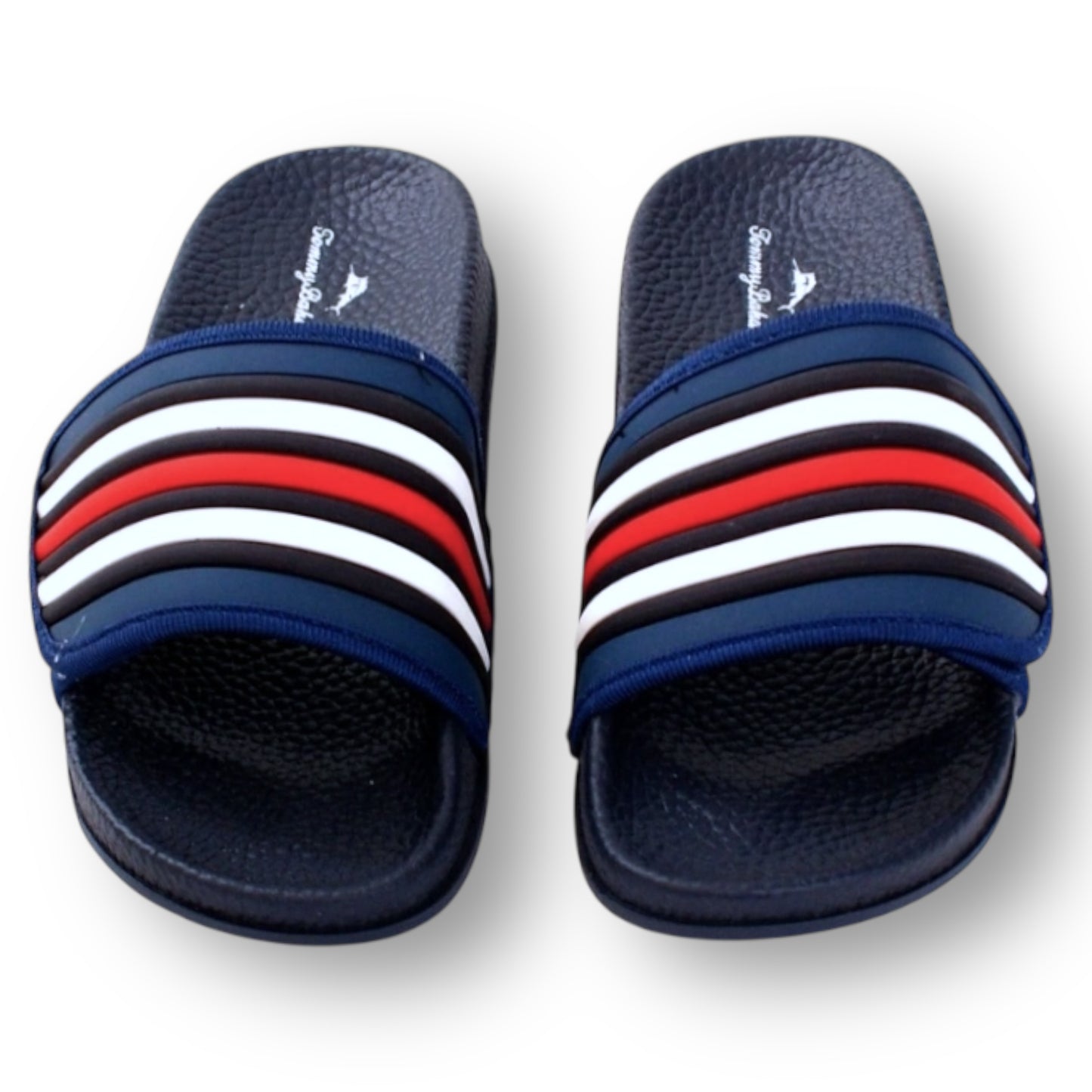 Pair of Tommy Bahama navy slides with multicolor stripes on a white background