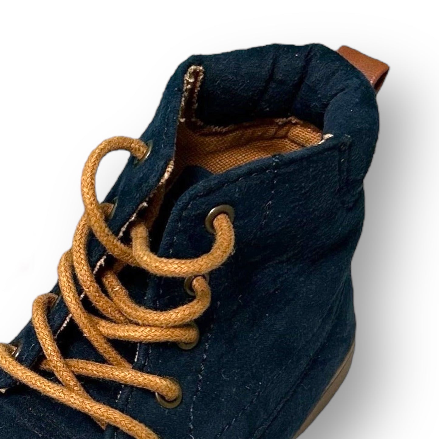 Close-up of a blue boot with brown laces on a white background