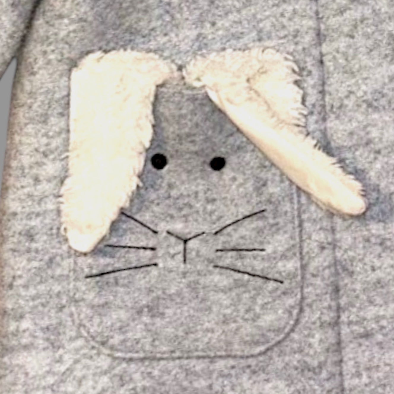 Gray hoodie with a bunny face design featuring white ears and black eyes.