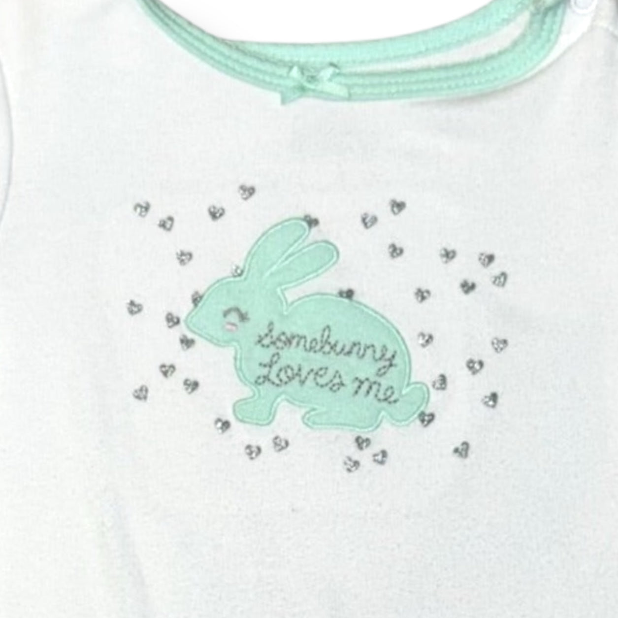 White shirt with a green bunny graphic and 'bunnymore loves me' text on a white background