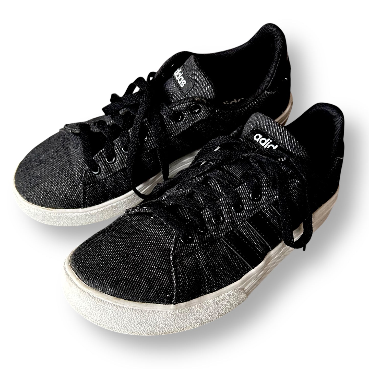 Black sneakers with white soles on a white background