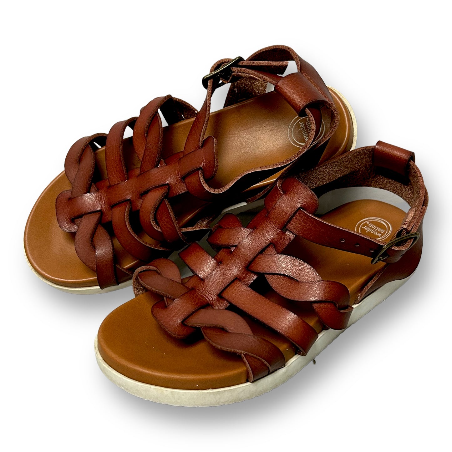 A pair of brown faux leather gladiator sandals with flat heels and buckle straps.