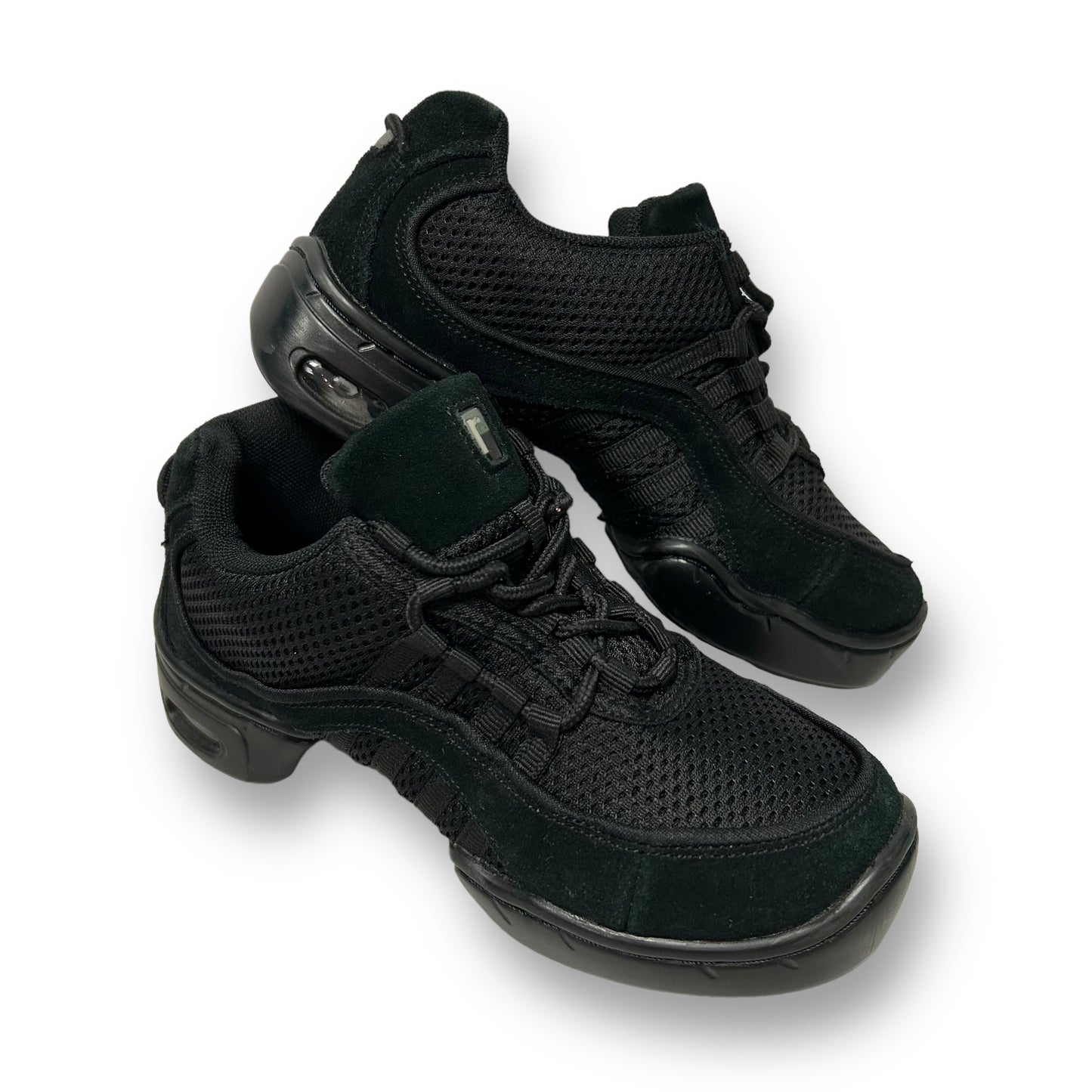 A pair of black Revolution youth girl size 5.5 split sole dance sneakers.