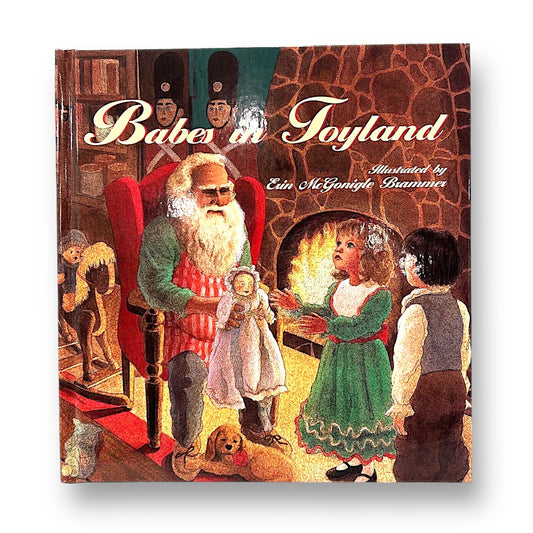 A cover illustration of the book 'Babes in Toyland' featuring Santa Claus presenting a toy to a young girl, with her parents and a dog looking on in a cozy room.