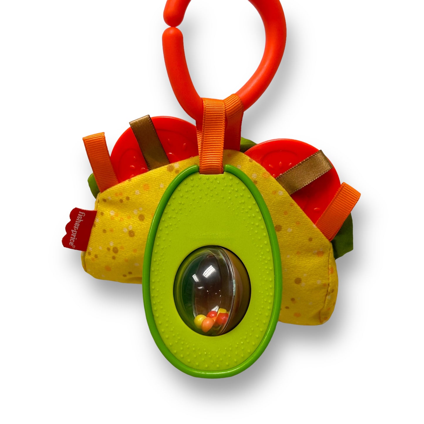 A colorful Fisher-Price Taco Tuesday Avocado Rattle & Taco Baby Toy with a green avocado-shaped body, orange straps, and a clear window revealing a taco rattle inside.