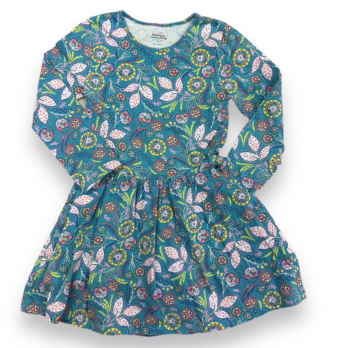 A long sleeve girls' dress with teal paisley print on a blue background, displayed facing front and back.