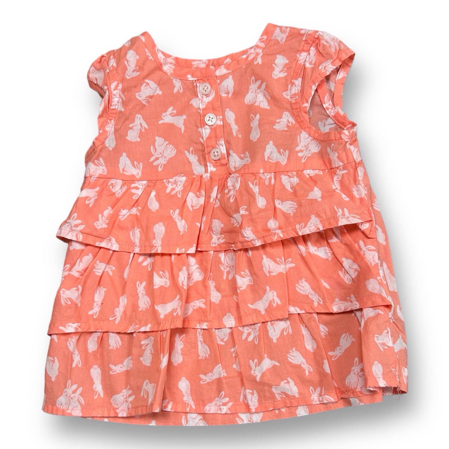Girls' sleeveless peach ruffle blouse with a pattern of bunny rabbits, designed for 12 months old.