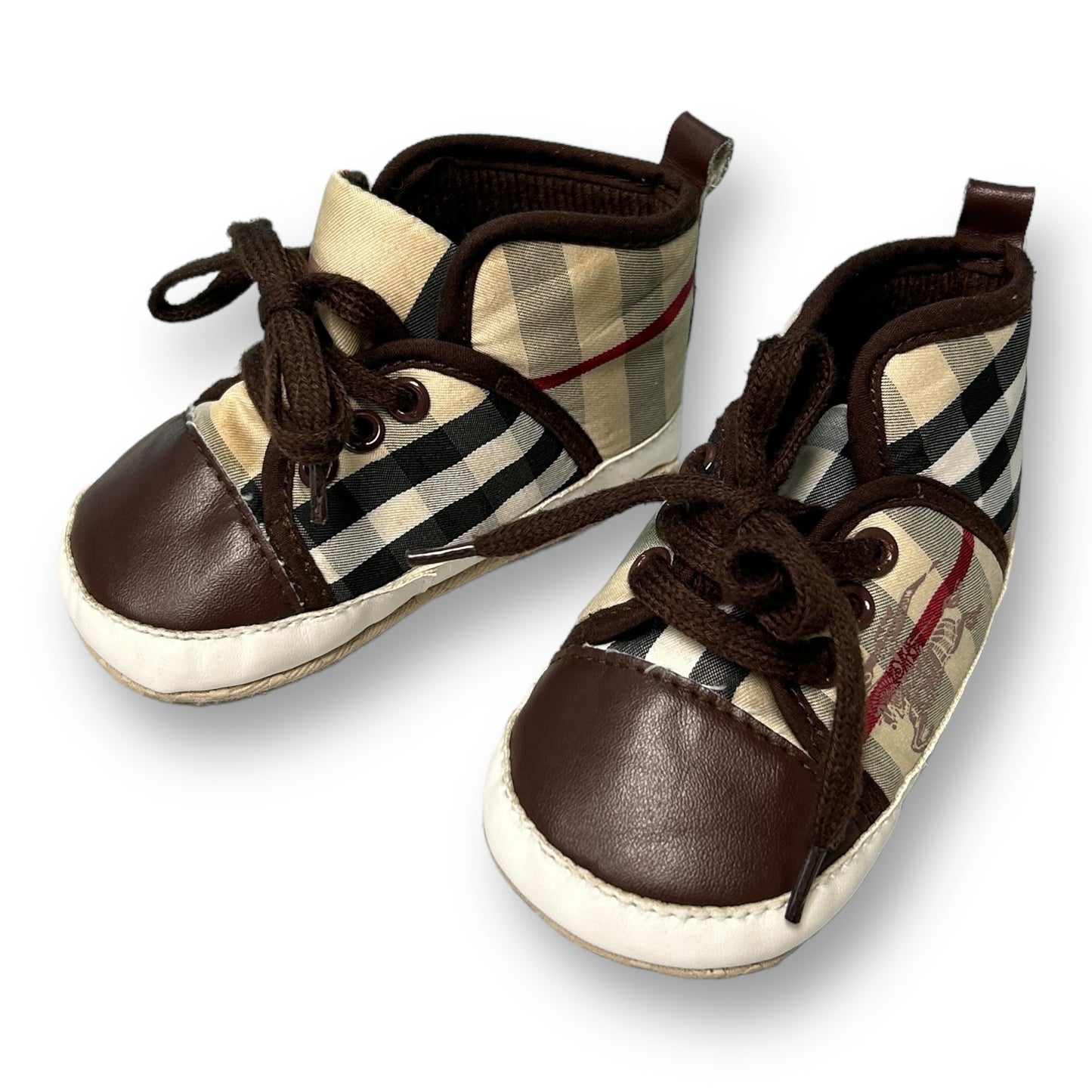 A pair of brown plaid soft-soul baby boy boots with lace-up closure.