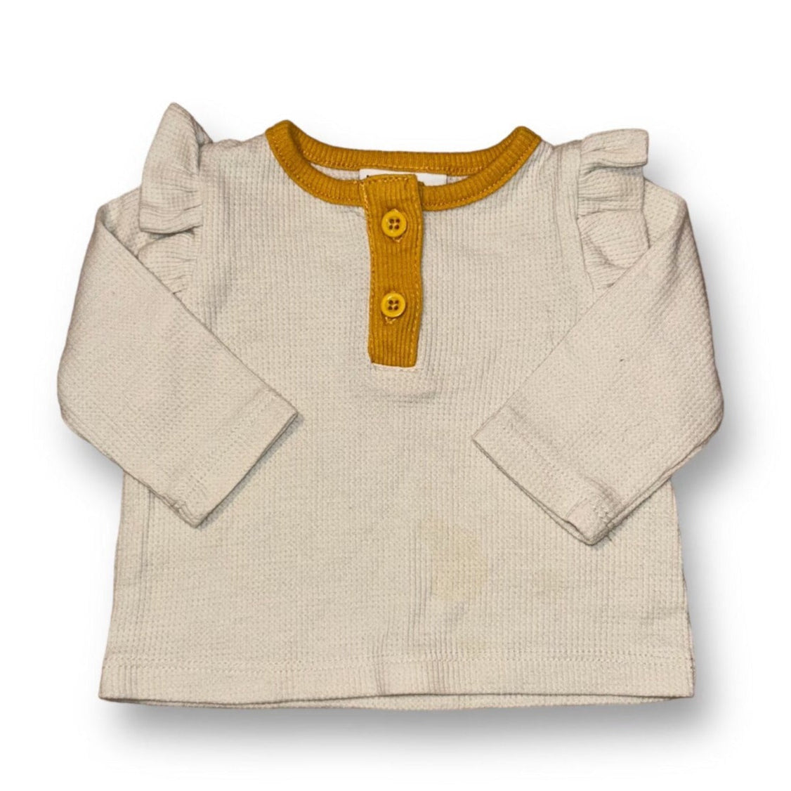 A beige thermal ruffle shirt for girls, with long sleeves and a yellow collar, presented against a white background.