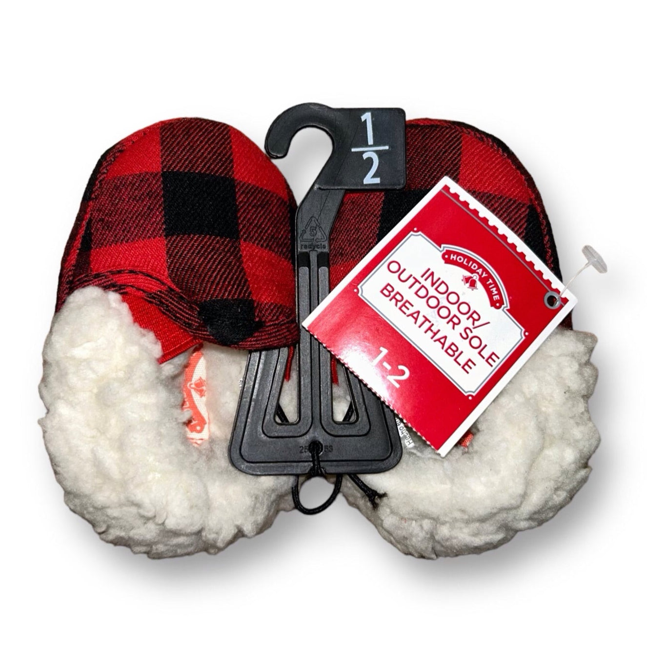 A pair of red and black checkered baby slippers with a '1-2' size indicator' and a Holiday Time brand tag attached to a hook.