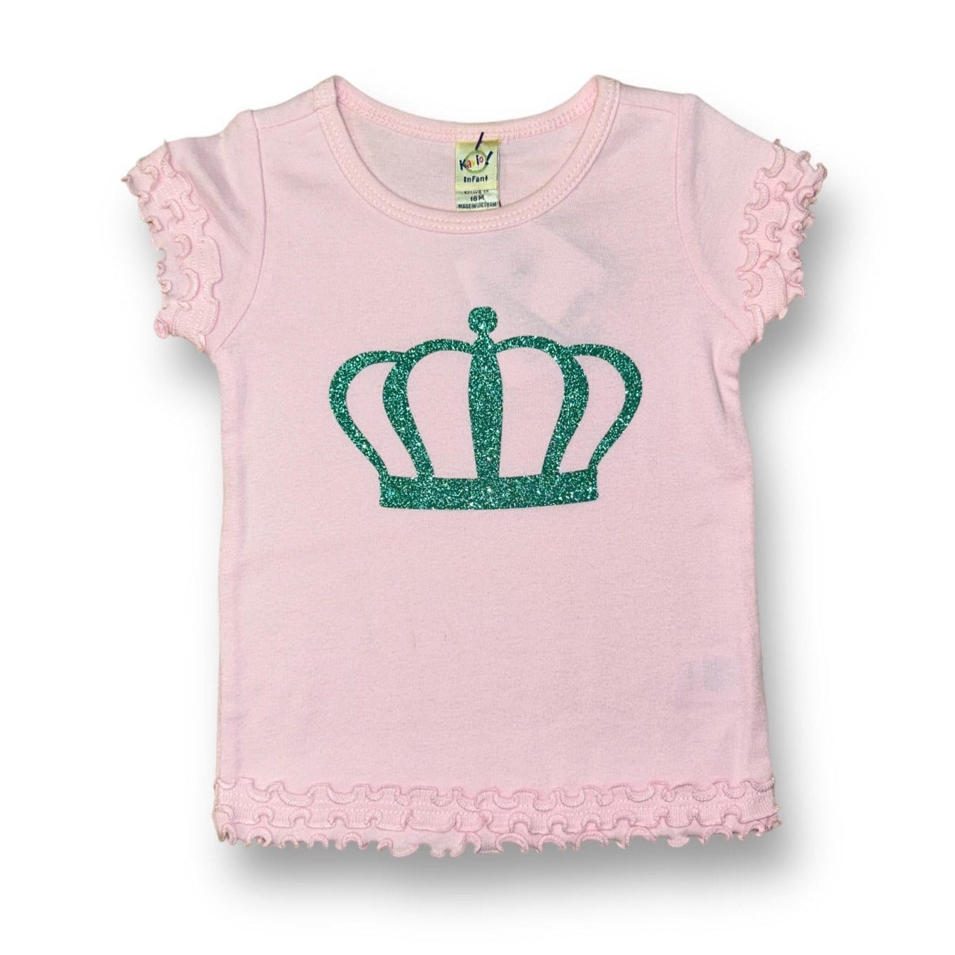 A light pink boutique top with princess ruffle sleeves and a green crown emblem on the front.