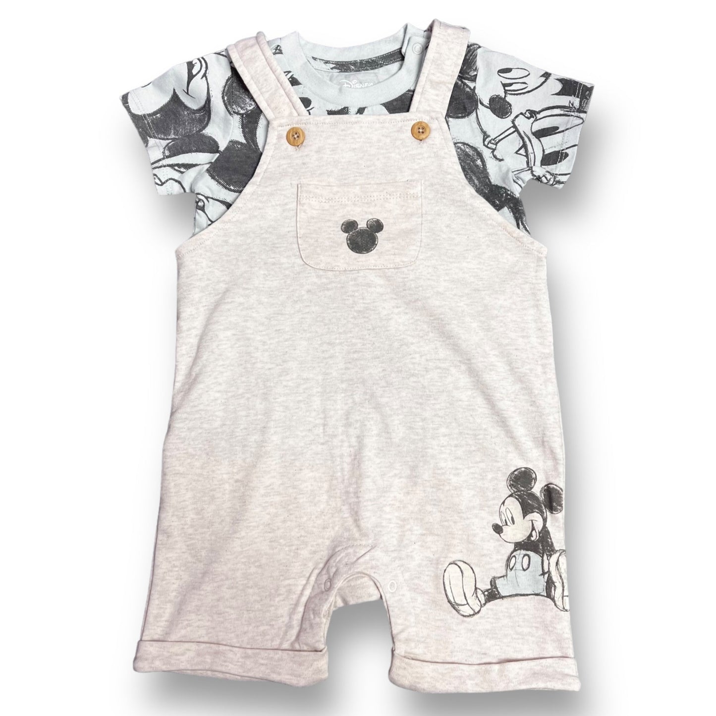 A boys' Disney Baby size 24 months outfit featuring a shirt with character graphics and an accompanying pair of overalls, both in blue and beige colors.