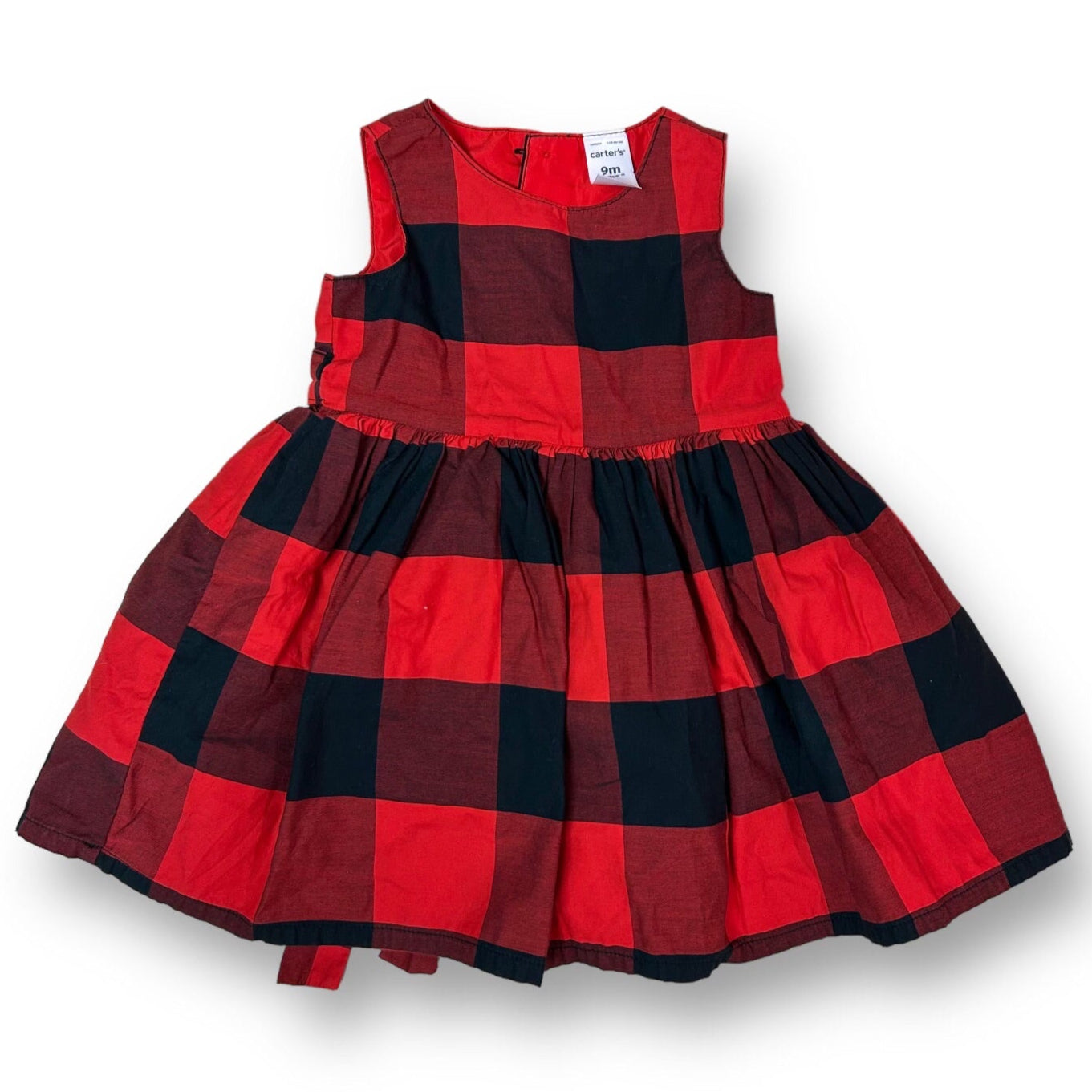 A red and black checkered tie-back dress for girls, displayed on a mannequin.