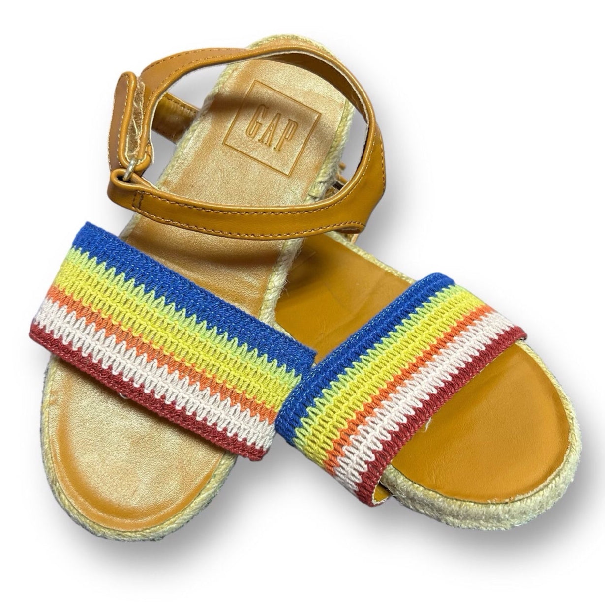 A pair of Gap Big Girl Size 11 Woven Rainbow Easy-Fasten Sandals with a brown sole and multicolored woven strap.