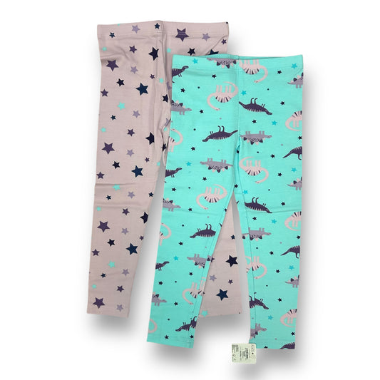 A pair of girls' leggings with dinosaur print in shades of purple and aqua colors.