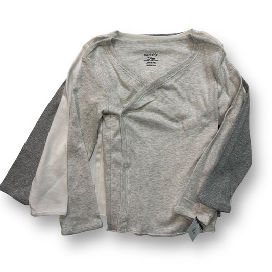 A long sleeve side-snap tee in white and gray colors, for a size 24 months, with visible snap closure.