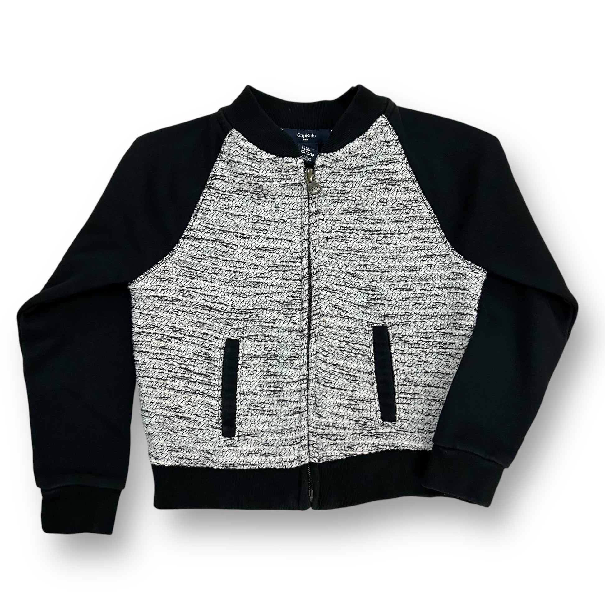 A girls' Gap jacket in black and white with a zippered front and a round neckline.