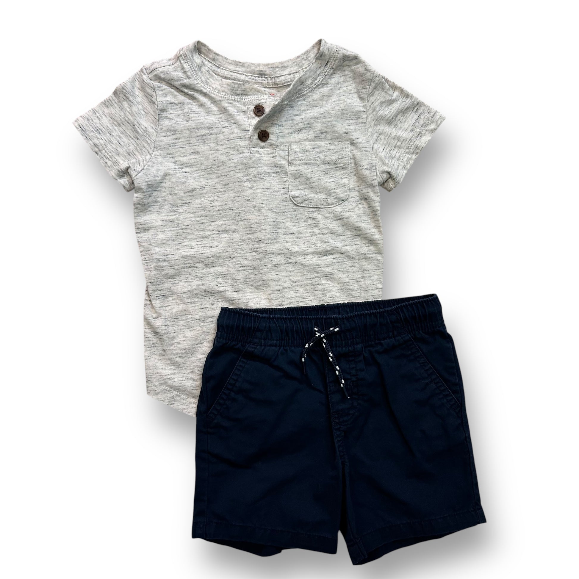 A navy blue pair of shorts and a gray henley shirt for a toddler.