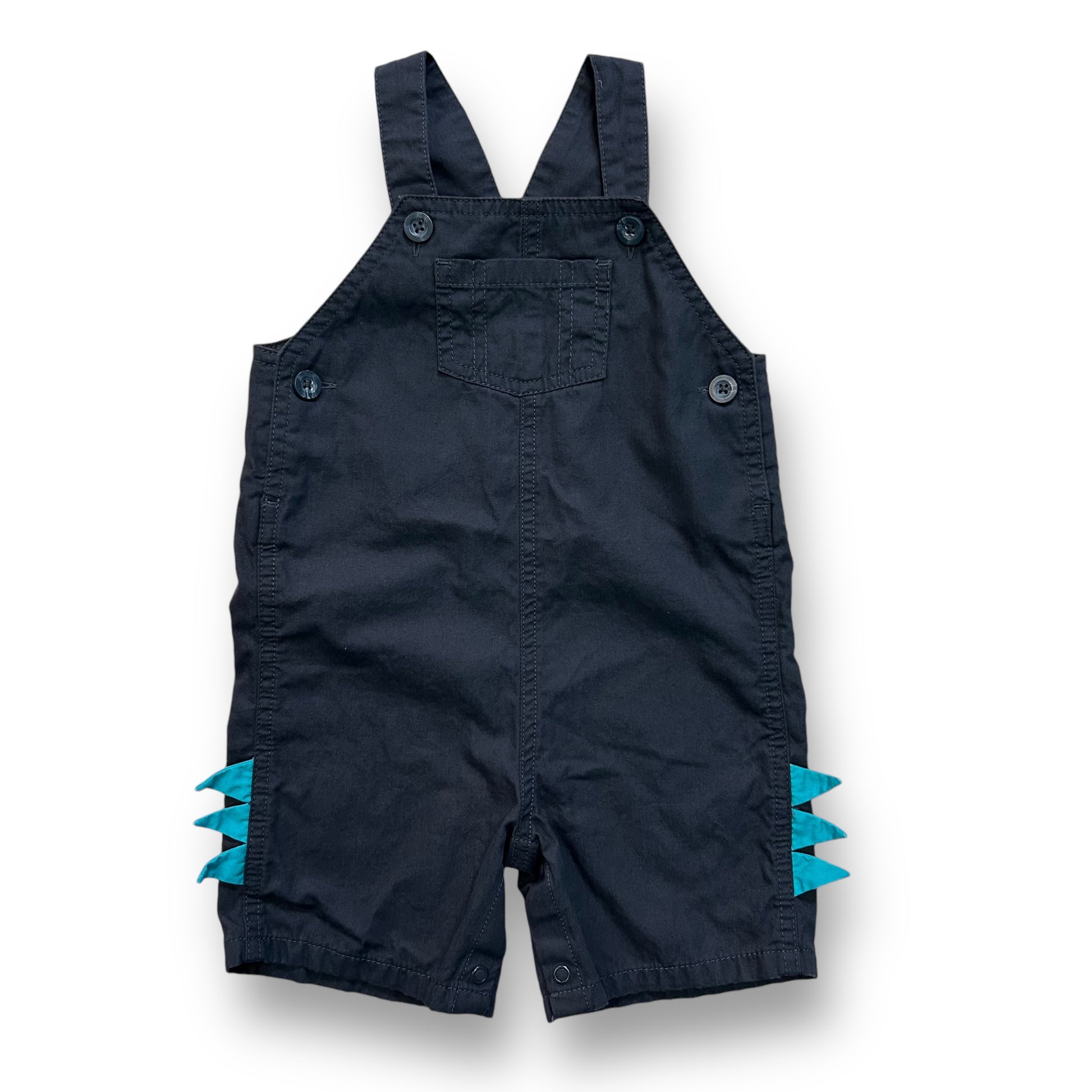 A pair of dark gray baby overalls with dino accents on the legs, featuring a one-piece design.
