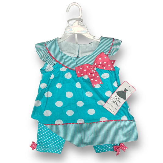 A girls' 2-piece outfit with pink and aqua stripes and polka dots, displayed on a hanger.