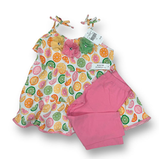 A girls' summer outfit set featuring a spaghetti strap top with citrus fruit prints and a coordinating skirt, both in pink and white colors.