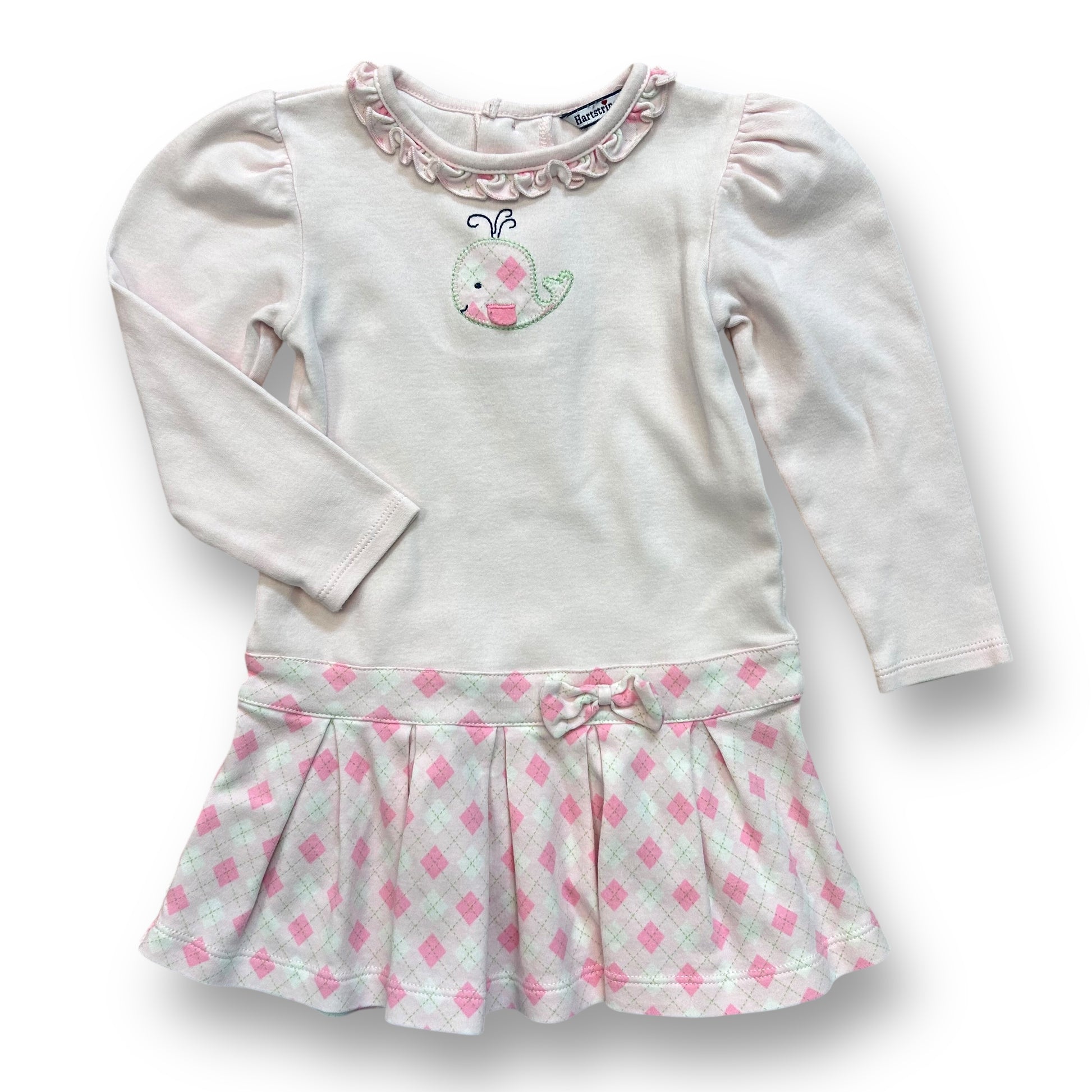 A pale pink long sleeve dress with a whale design on the sleeve, and a green and white checkered pattern on the skirt, for a 24 month old girl.