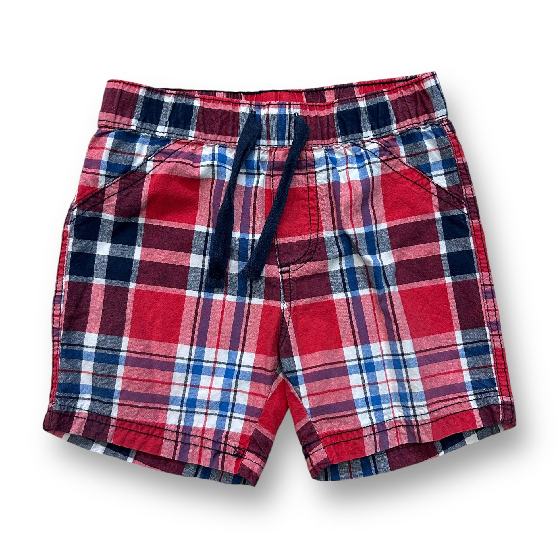A pair of red, white, and blue plaid shorts for boys.