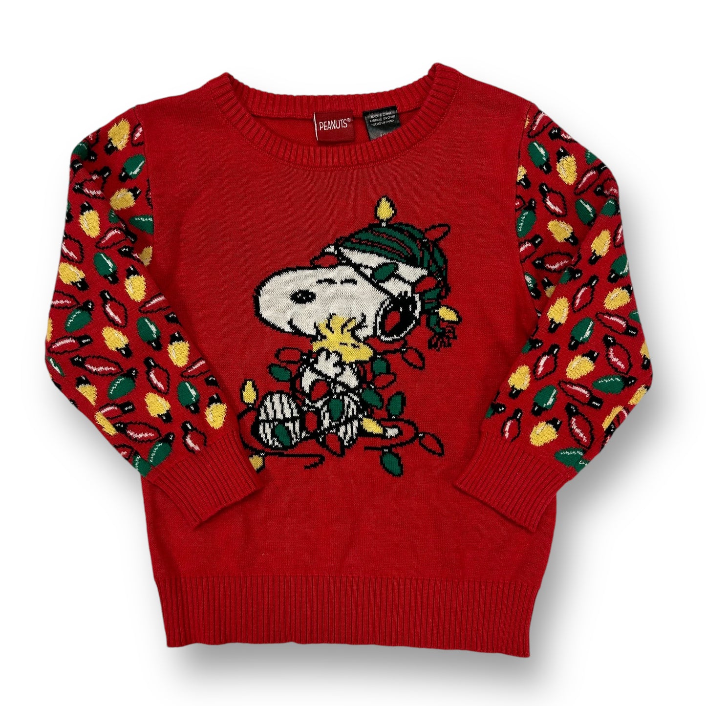 A red Christmas-themed sweater featuring a 'Peanuts' character design, with green and red decorations on a knitted texture.
