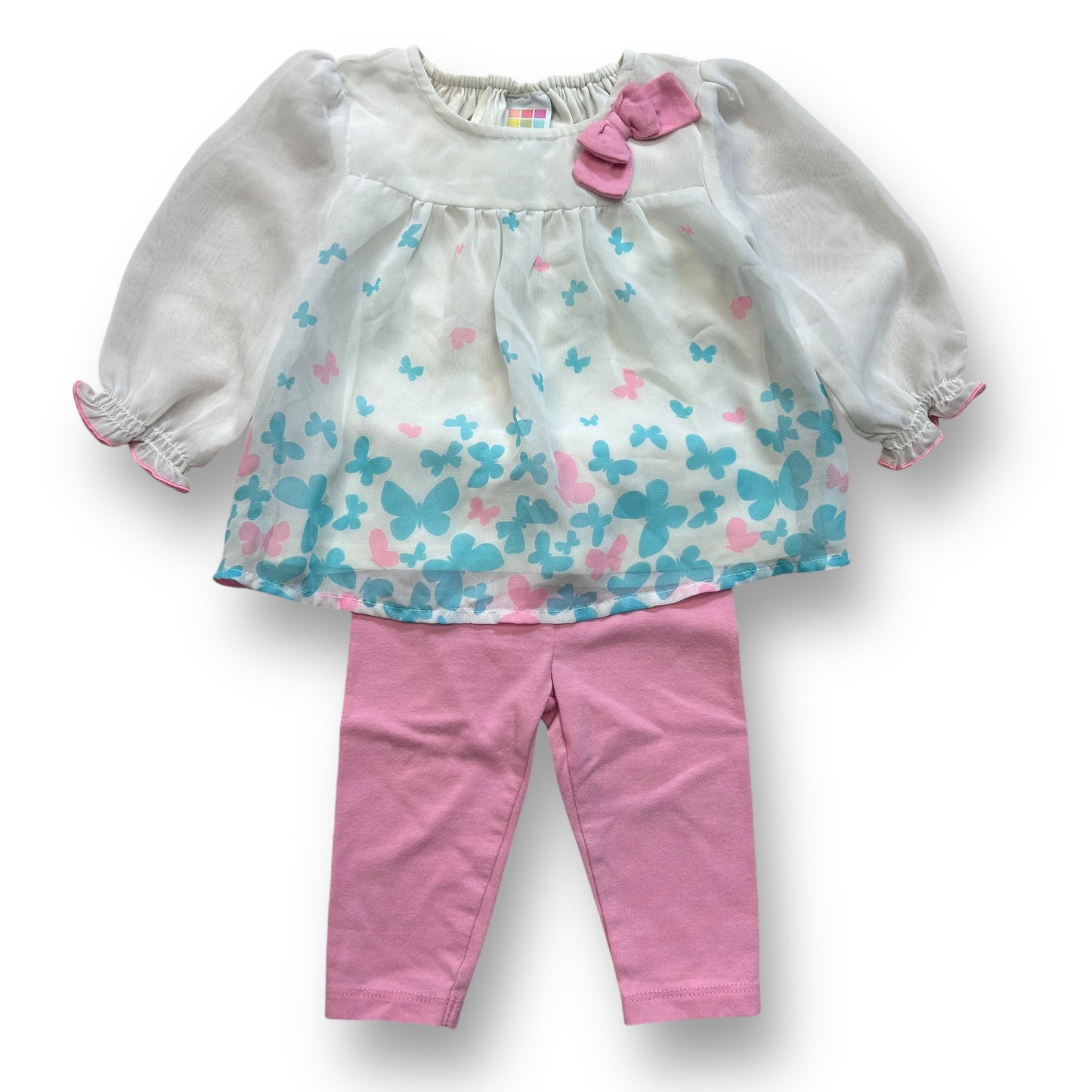 A girls' outfit with a white and pink butterfly blouse and pink leggings.